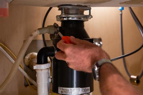 how to remove hose from garbage disposal