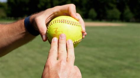how to teach a beginner to throw a softball