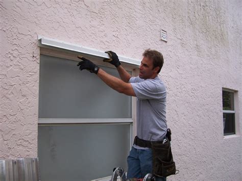 hurricane shutter track installation