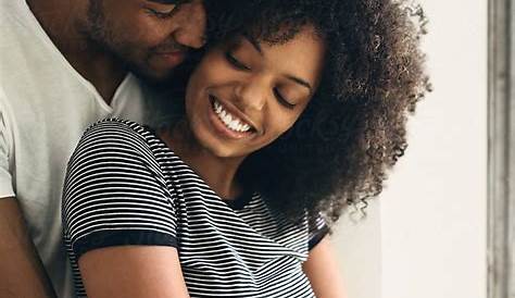 "Happy Embracing Black Couple Posing" by Stocksy Contributor "Dreamwood