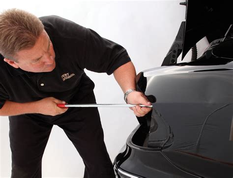 Image of a technician using a paintless dent repair method