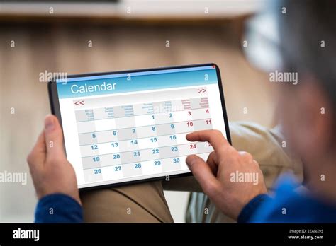 Image of man using a calendar