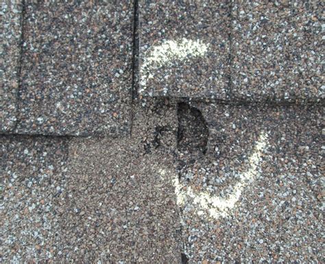Inspecting hail damage on roof