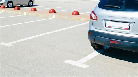 is it illegal to park in two parking spaces