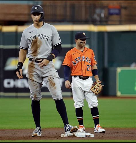 jose altuve standing next to aaron judge