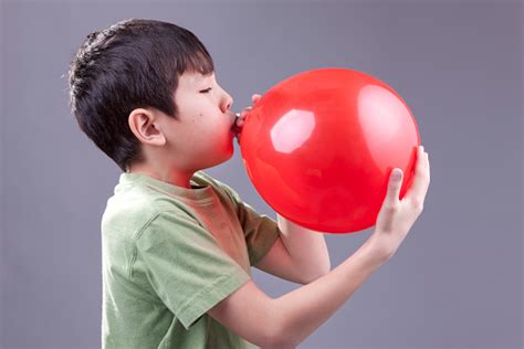 kid blowing up a giant balloon