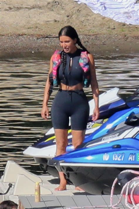 Kim Kardashian sizzles in a plunging black bodysuit while on a boat