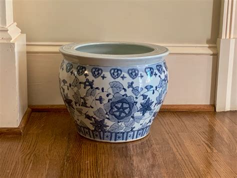 large oriental floor planter with coy on stand