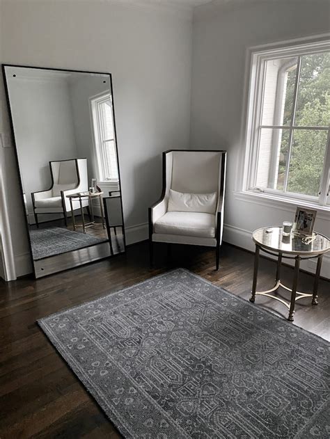 leaning mirror with rug infront