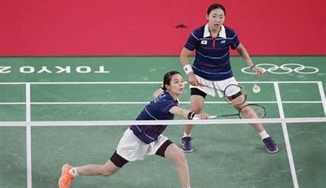 South Korea's Lee Yong Dae (R) and Jung Jae Sung play a shot against