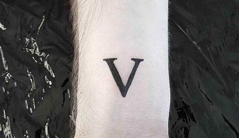 Minimalist V letter tattoo on the wrist.