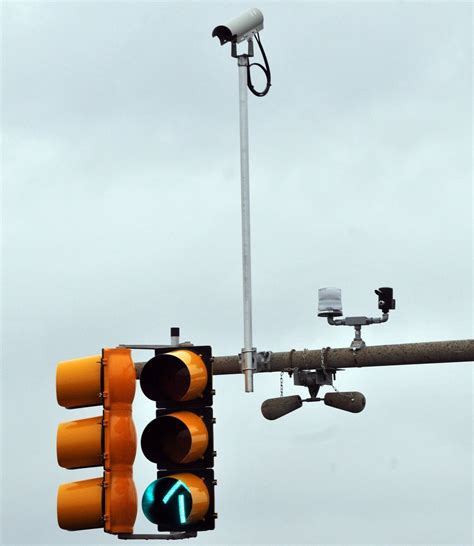 little black cameras on traffic lights