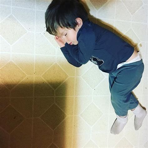little boy asleep kitchen floor