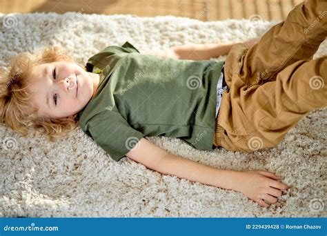 little boy lying on floor