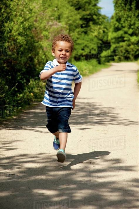 little boy running across a floor