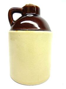 little brown ceramic jug with cork