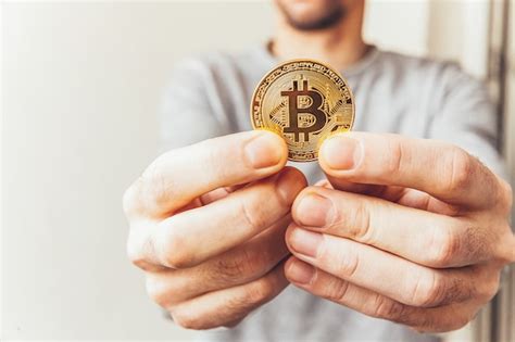 Man Holding Phone Displaying Bitcoin Cryptocurrency