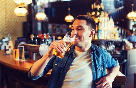 man drinking at a bar