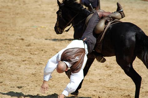 man falling off horse