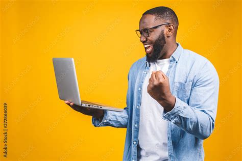 man looking at computer screen, excited