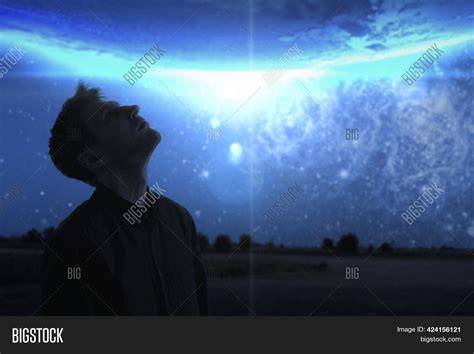 man looking up from darkness