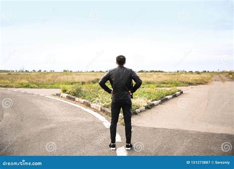 man standing at crossroads