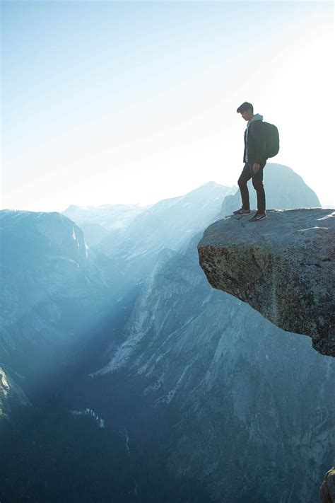 man standing on a cliff