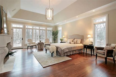 Tropical Master Bedroom with flush light, Hardwood floors