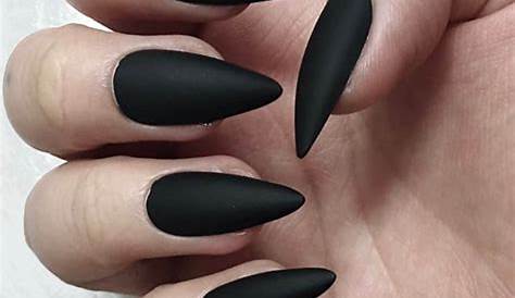 Stiletto nails in matte black with gold glitter and