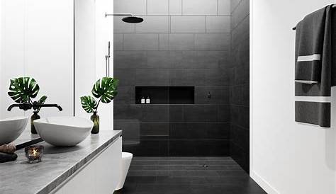 Matte black shower kit in a walk in shower featuring glossy white