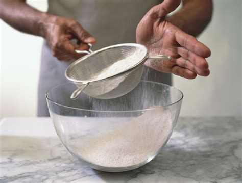 measuring sifted flour for recipes