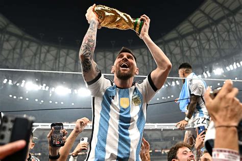 messi with the world cup trophy
