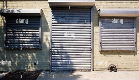 Metal gate protecting a store. Close shop Stock Photo