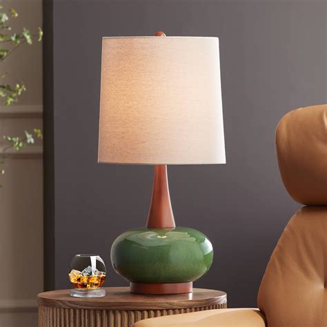 A mid-century table lamp used as an accent piece in a bedroom