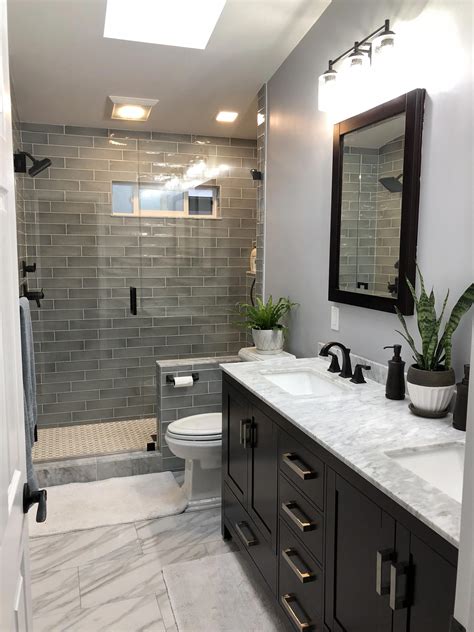 a bathroom with two sinks, a toilet and a walk in shower area that has