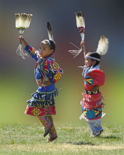 Native American youth dancing with traditional dresses
