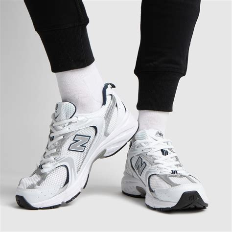 new balance 530 sneakers in white and silver