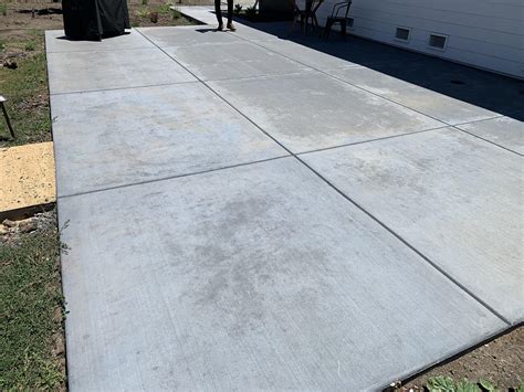 Newly poured concrete has dark spots and streaks throughout..HELP