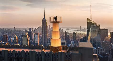 Visitors looking out from the observation deck of the Empire State Building, with breathtaking panoramic views of the city.