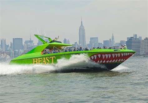 A speedboat zipping through the water near the Brooklyn Bridge, with people holding onto the railing for an exciting ride