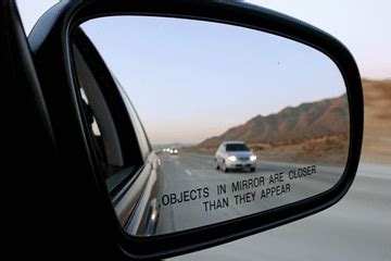 Rear View Mirror With Warning Text Objects In Mirror Are Closer Than They Appear, Isolated Stock