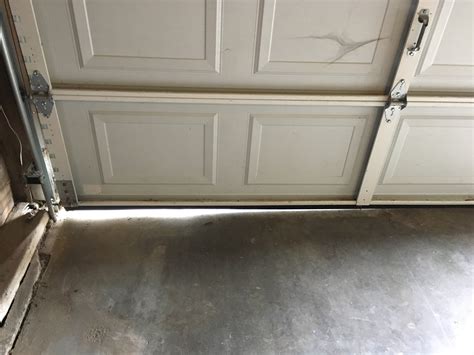 one side of garage door has gap