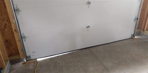 one side of garage door higher
