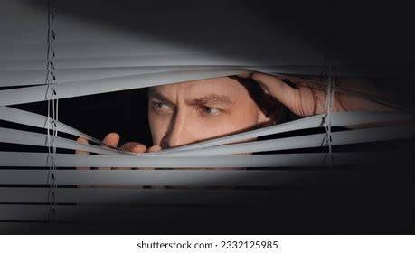 Paranoid Eyes Peering Through a Window