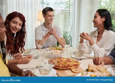 people around dinner table talking