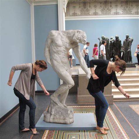people interacting with statues