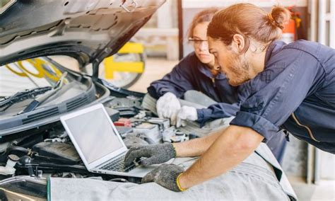 Man installing a performance car upgrade on a sports car