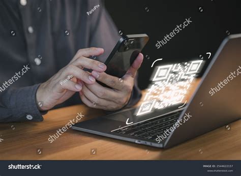 Image of a person using a smartphone to scan a document.