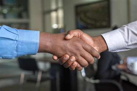 photo of 2 people shaking hands