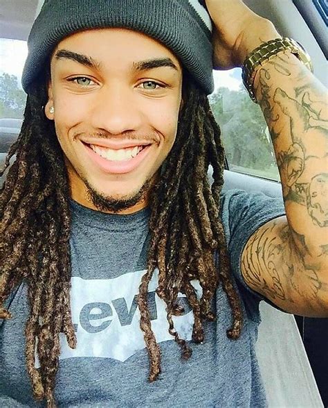 picture of guy with dreads and tattoos